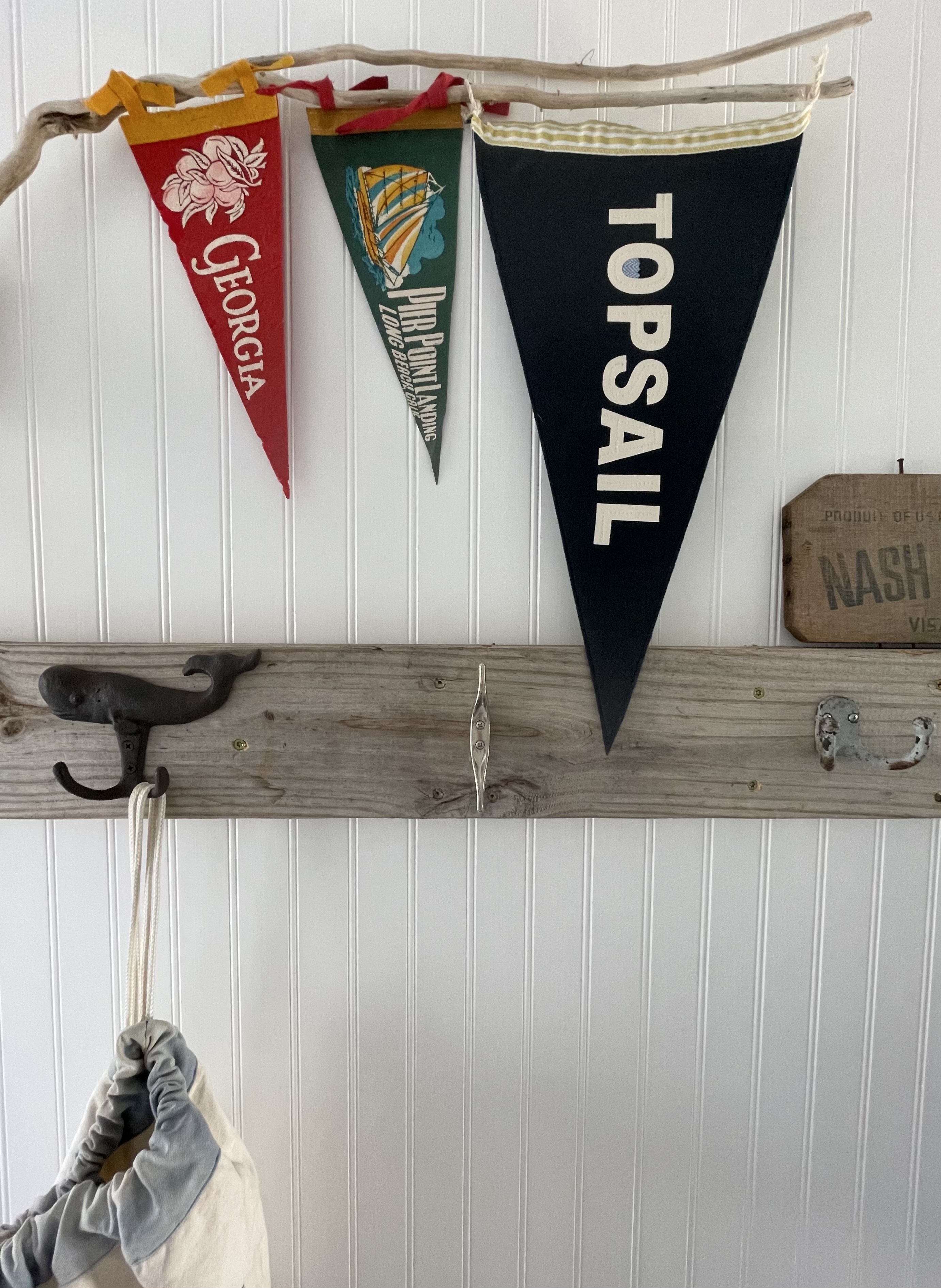 Pennants displayed on driftwood